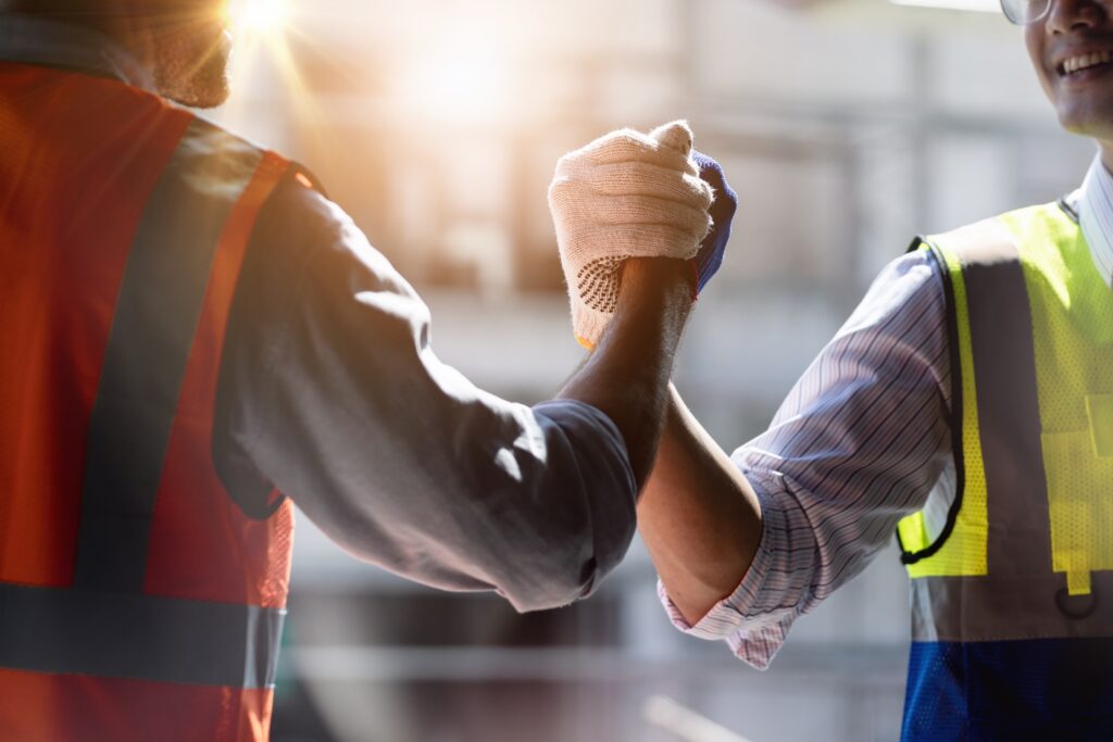 Two Construction Workers Celebrating A Job Well Done